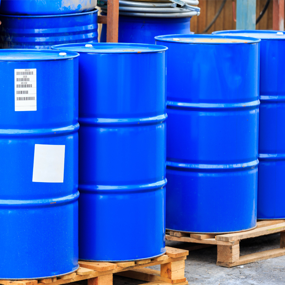 Technician collecting used cooking oil from restaurant storage tank